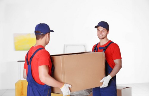 Man and van removals team working in Canary Wharf near modern apartment buildings